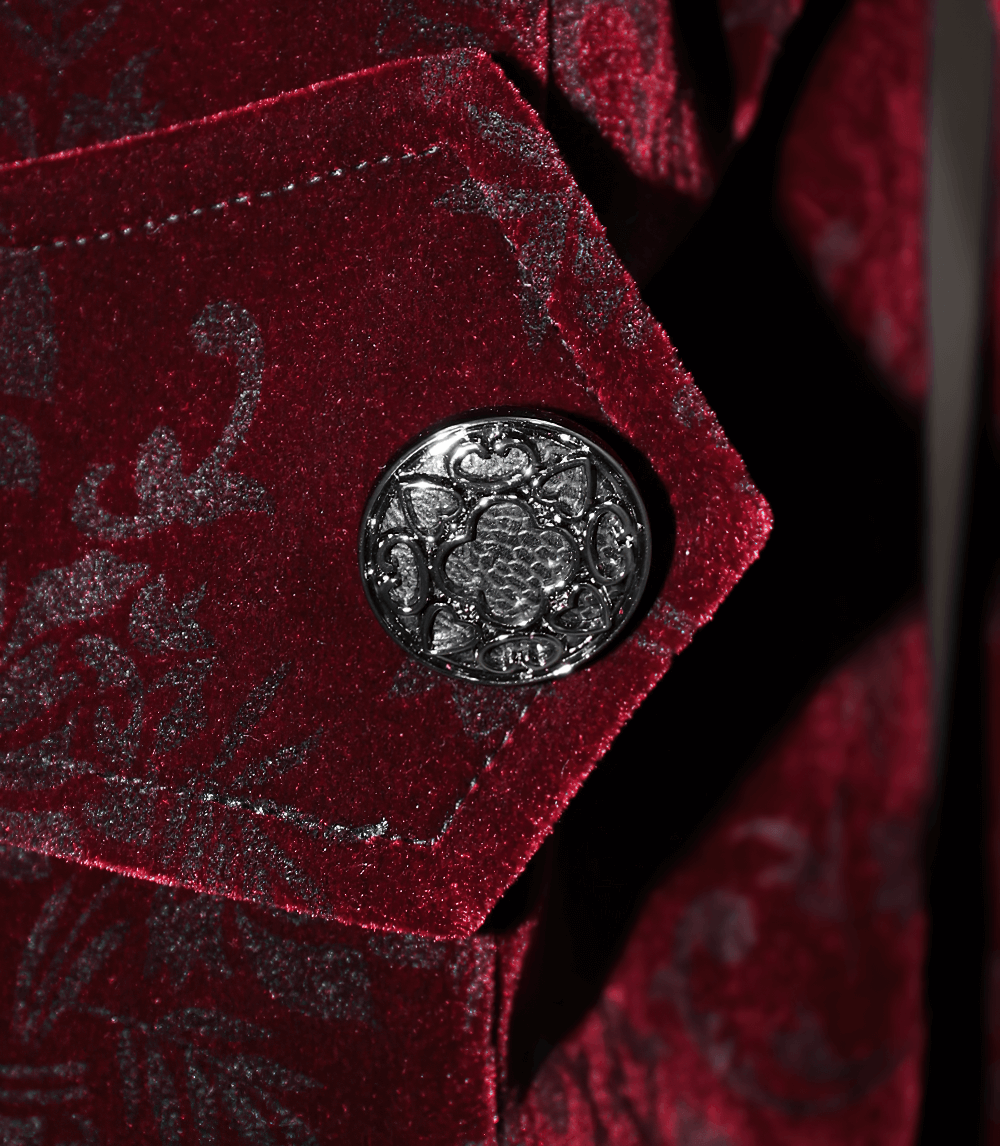 Close-up of vintage gothic wine red velvet jacket with ornate silver button detail.
