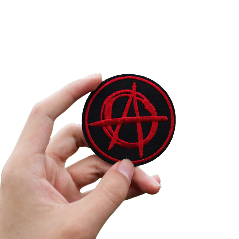 Hand holding a unisex anarchist symbol patch in red and black, perfect for alternative fashion and rock style.