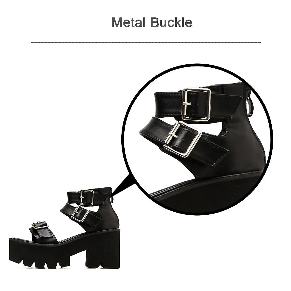 Close-up of black ankle strap platform sandals featuring a stylish metal buckle detail.