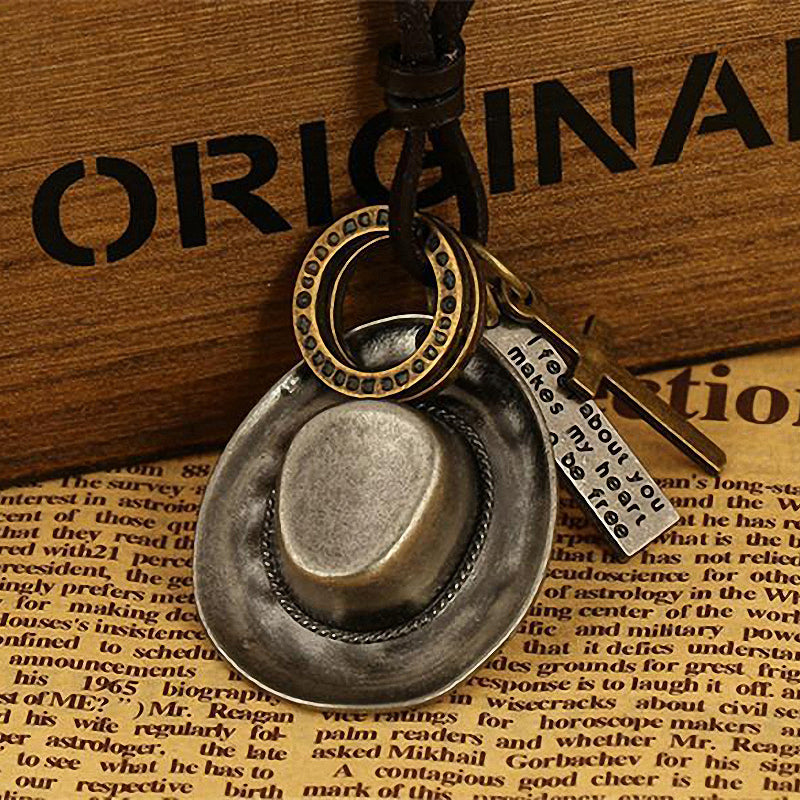 Antique cowboy hat pendant necklace with rings and crosses on a leather rope chain, perfect for Western fashion enthusiasts.