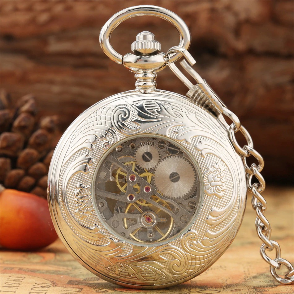 Antique mechanical pocket watch featuring intricate silver engravings and a visible gear mechanism.
