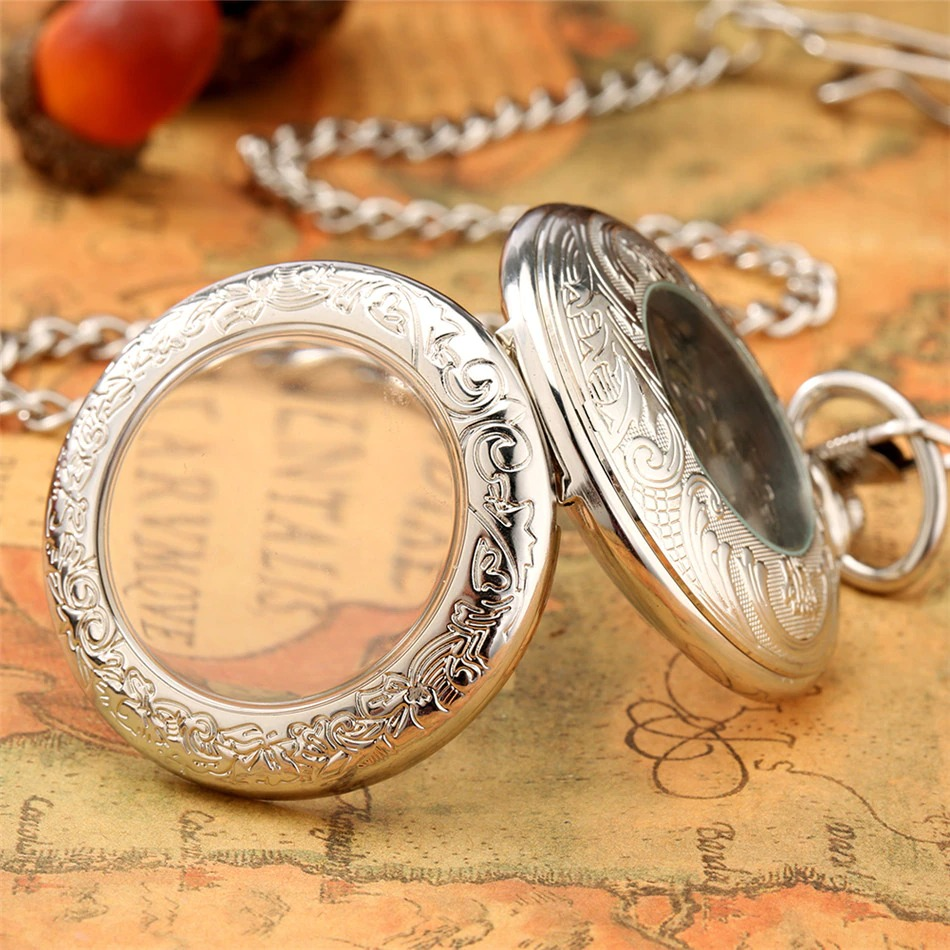 Antique mechanical pocket watch with intricate silver engraving and glass cover, perfect for collectors and gifts.