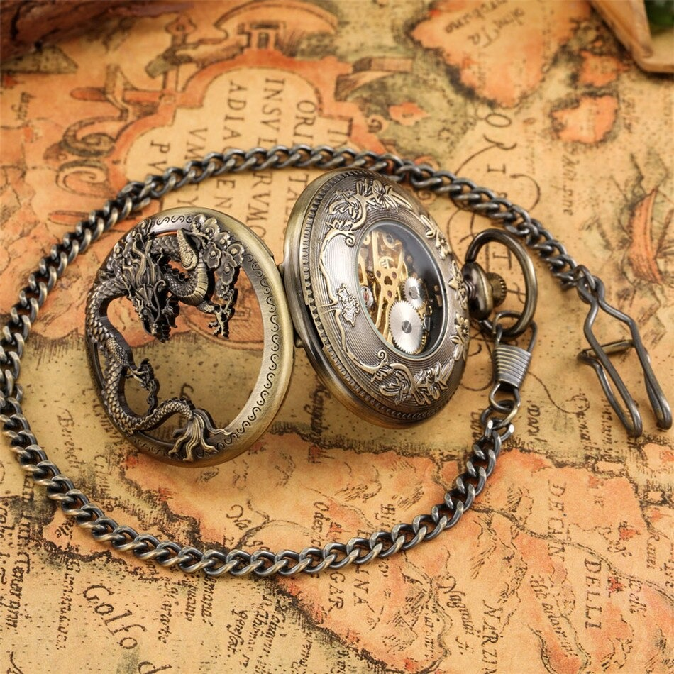 Antique mechanical pocket watch with bronze dragon design, detailed gears showing, on vintage map background.
