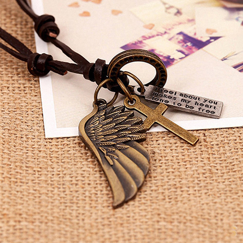 Antique vintage angel wing leather necklace with cross and text pendant charms on a woven background.