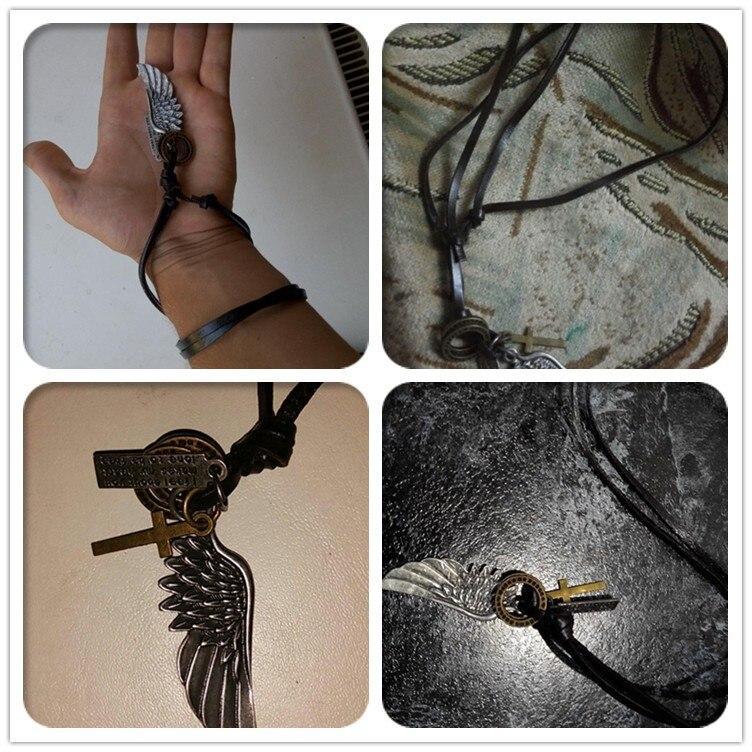 Antique vintage angel wing leather choker necklace with charms, perfect accessory for a trendy concert outfit.