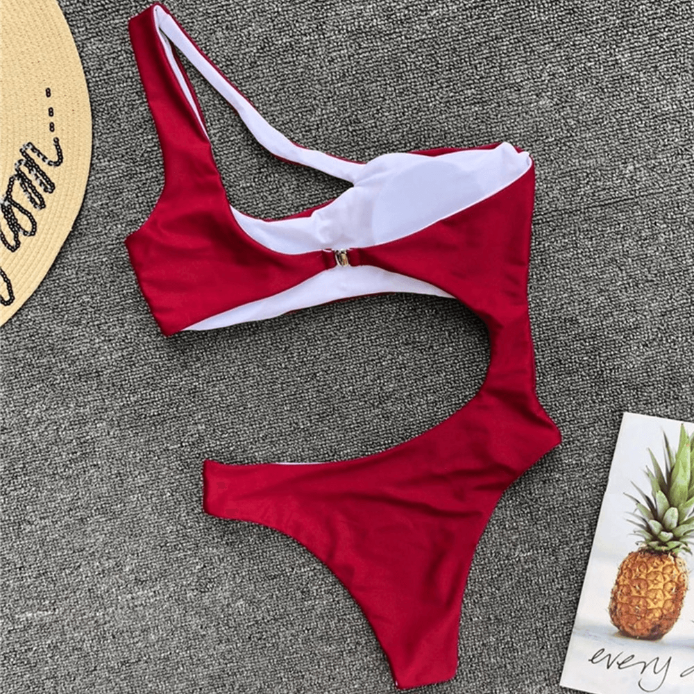 Stylish asymmetrical red one-piece bikini swimsuit design for women, perfect for summer beach outings.