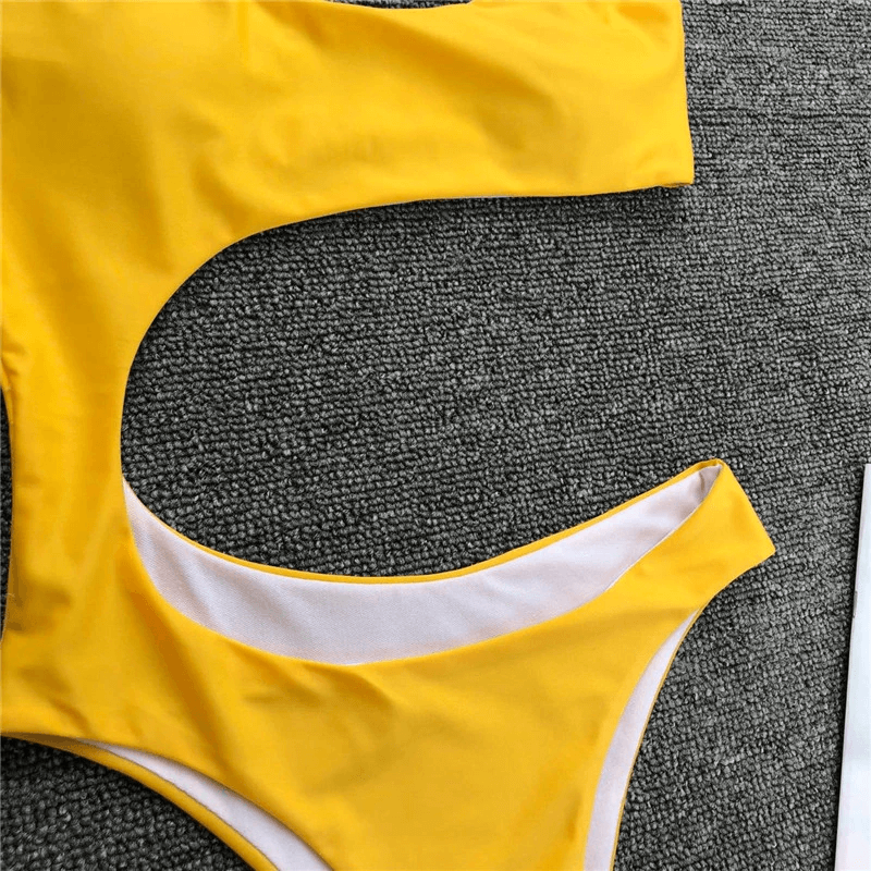 Stylish yellow asymmetrical one-piece swimsuit for women, showcasing a trendy cut and casual style.