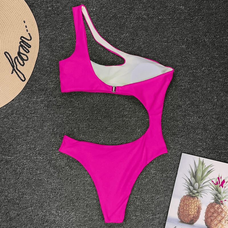Asymmetrical bright pink one-piece swimsuit for women, stylish casual monokini with unique design.