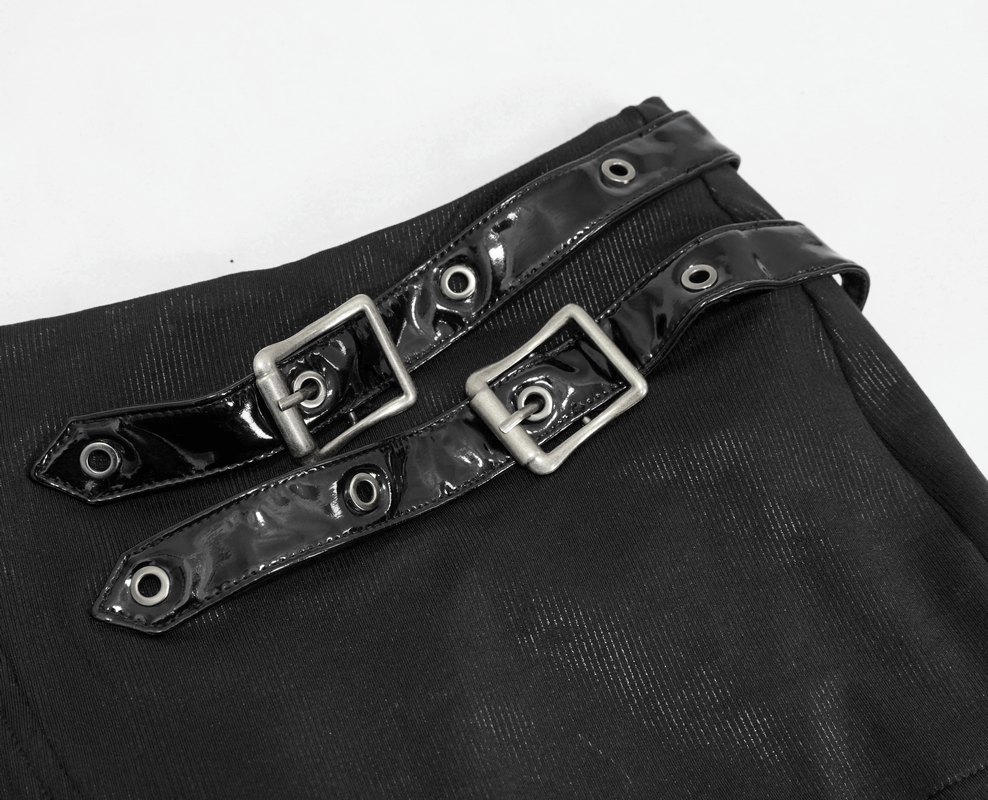 Close-up of gothic black mini skirt with shiny buckles and lacing details, showcasing its stylish design.