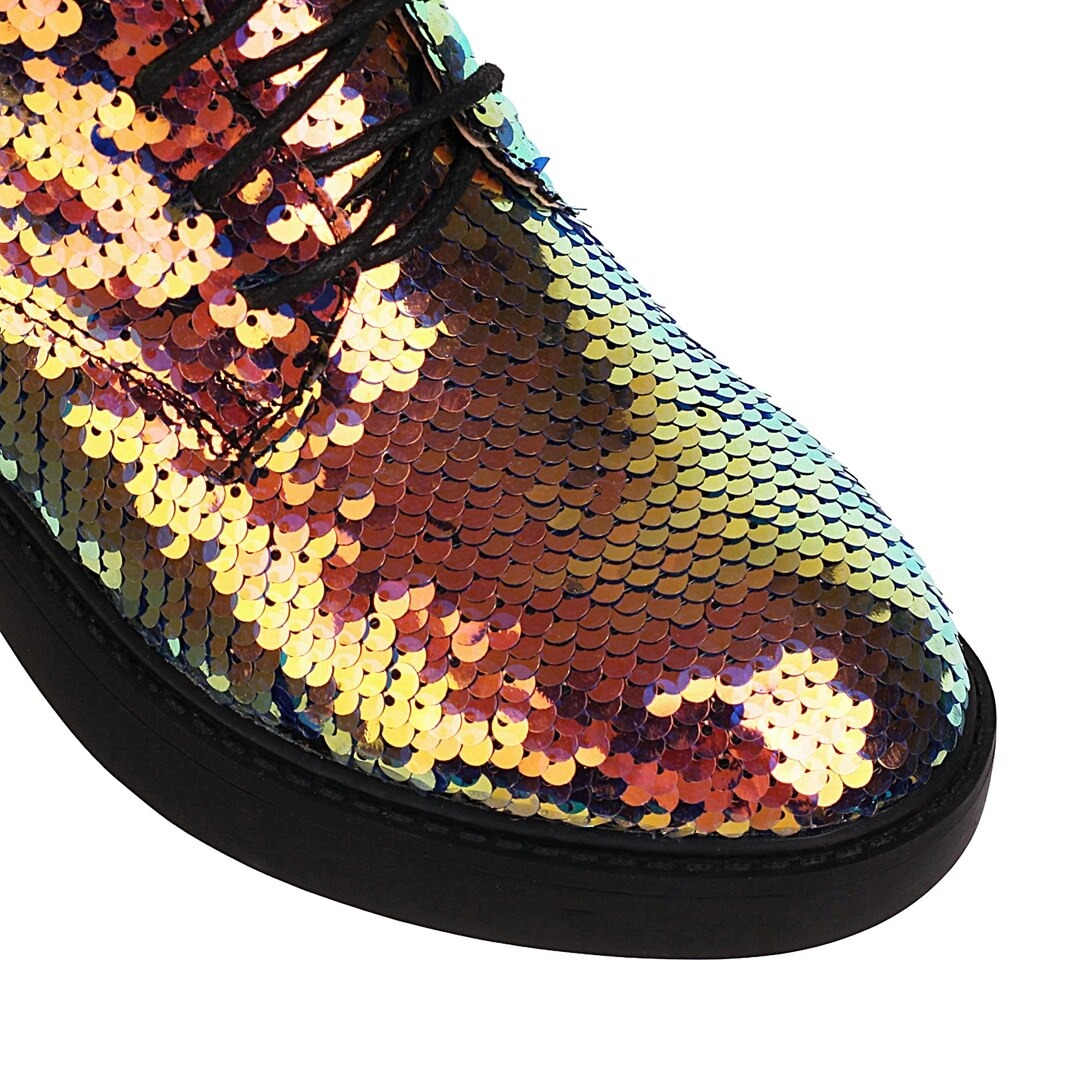 Close-up of shimmering sequins on women's PU leather ankle boots in vibrant colors.