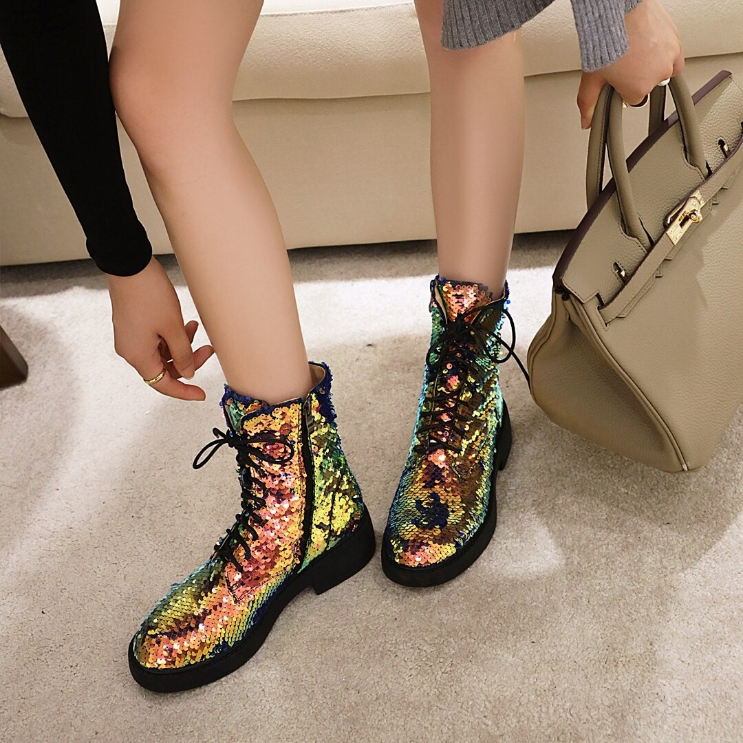 Colorful women's sequined ankle boots paired with a stylish handbag, perfect for autumn and winter fashion.