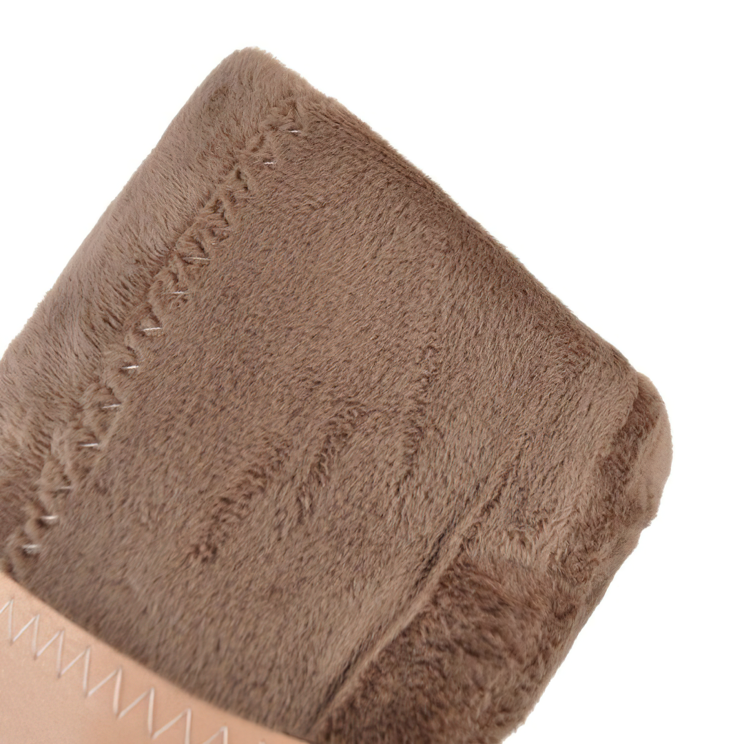 Close-up of soft, brown faux fur detailing on women's PU leather boots, showcasing premium quality and comfort.