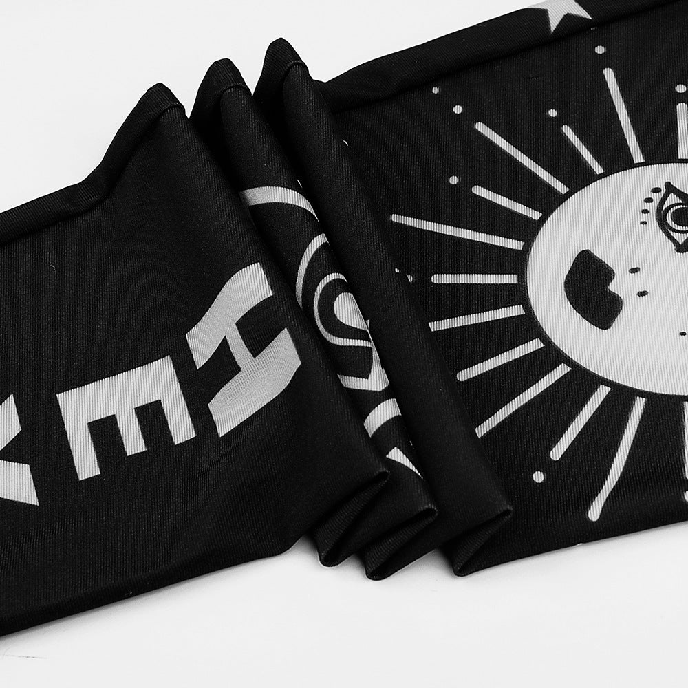 Close-up of black and white Bad Girl leggings featuring symbols and a moon design, perfect for goth style.