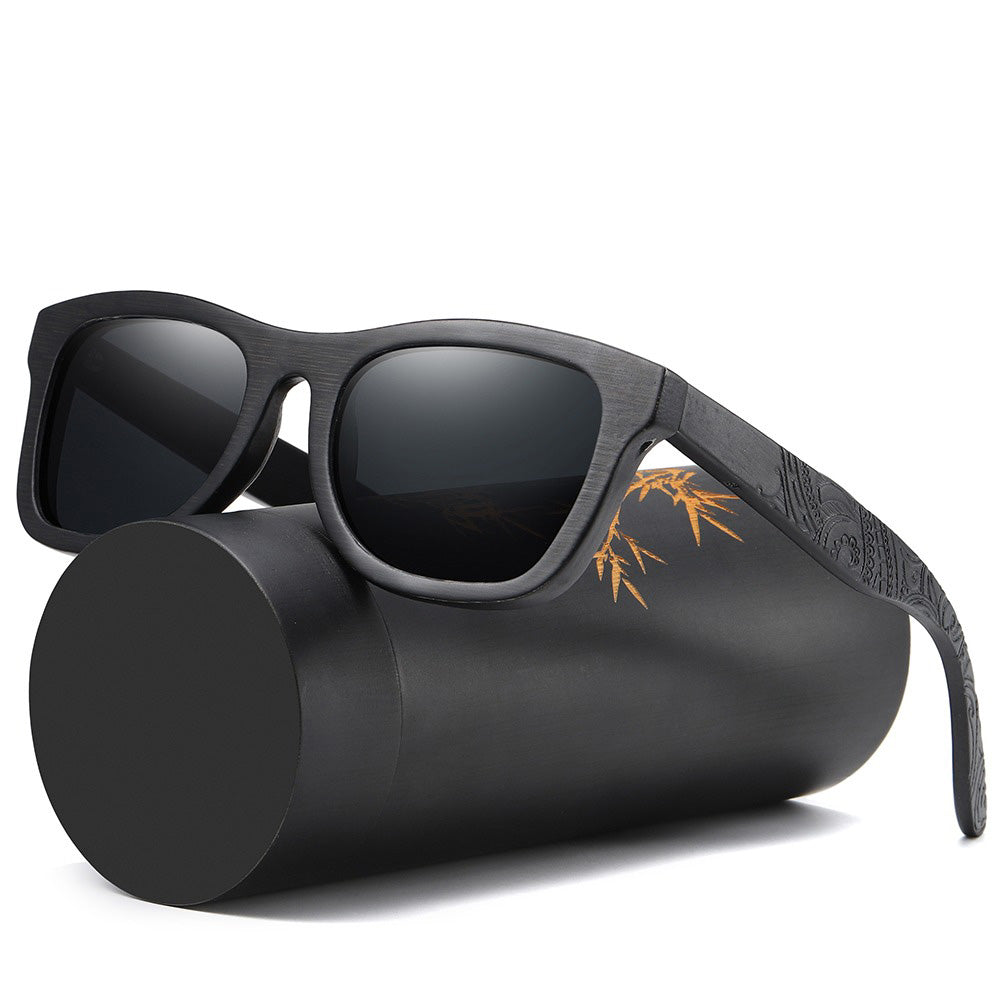 Stylish bamboo polarized unisex sunglasses resting on a sleek black cylindrical case, perfect for casual fashion.