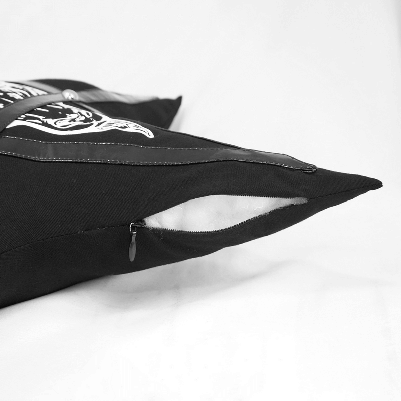 Close-up of gothic black pentagram cushion with faux leather trim and zipper detail.
