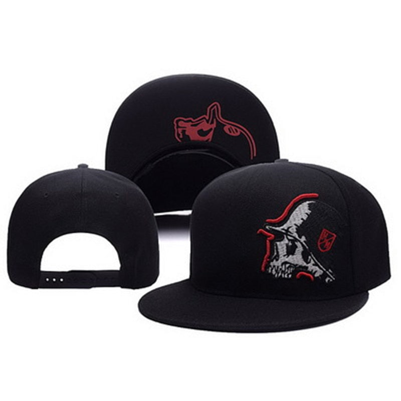 Black baseball cap with red skull embroidery and flat brim, showcasing alternative fashion style.