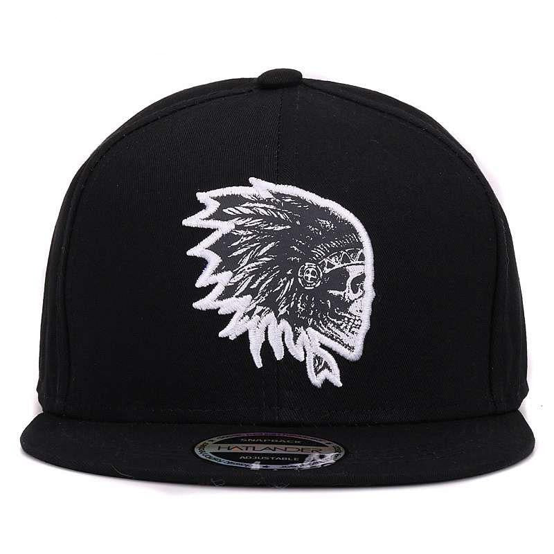 Black snapback cap with white embroidered skull and feather design, perfect for a bold rock style.