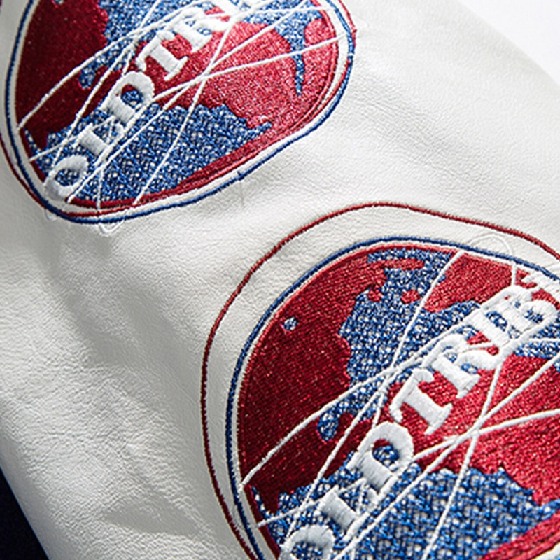Close-up of baseball jacket embroidery patch featuring colorful globe logo in red and blue on a white background.