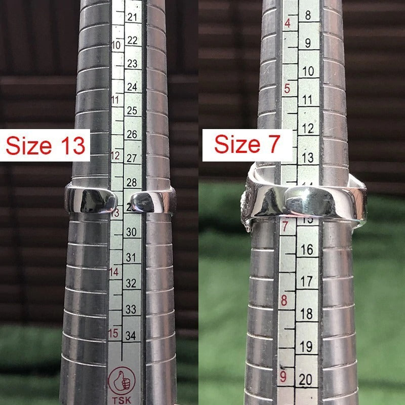 Comparison of ring sizes 13 and 7 on a sizing mandrel for men's 925 sterling silver skull ring.