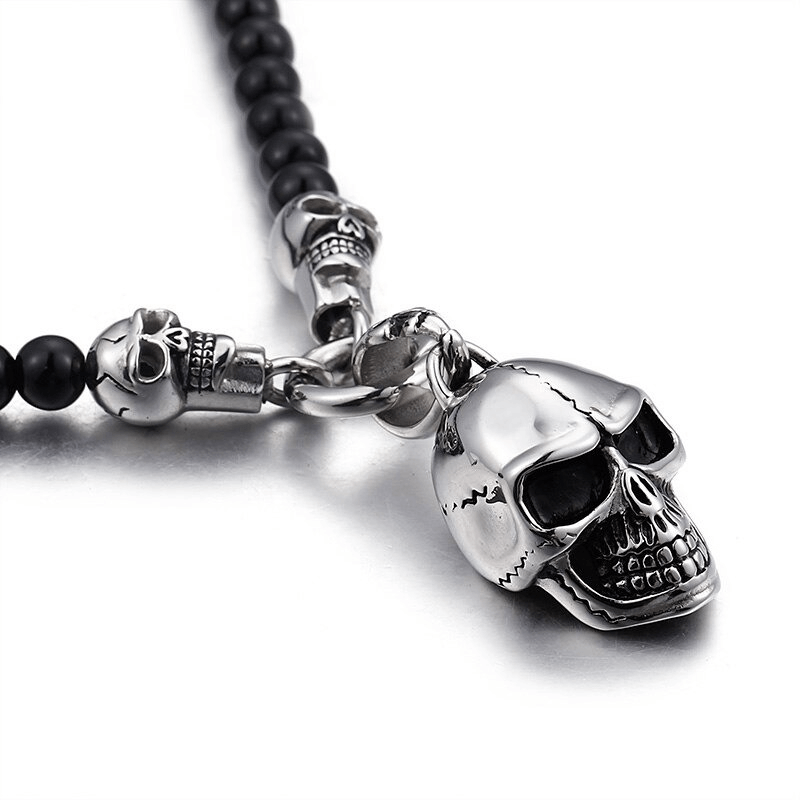 Biker chain necklace with black beads and stainless steel skull pendant, perfect for rock style enthusiasts.