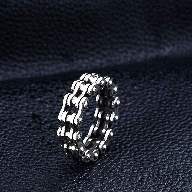 Biker chain stainless steel ring, unique rock style jewelry designed for men and women, set on black leather background.