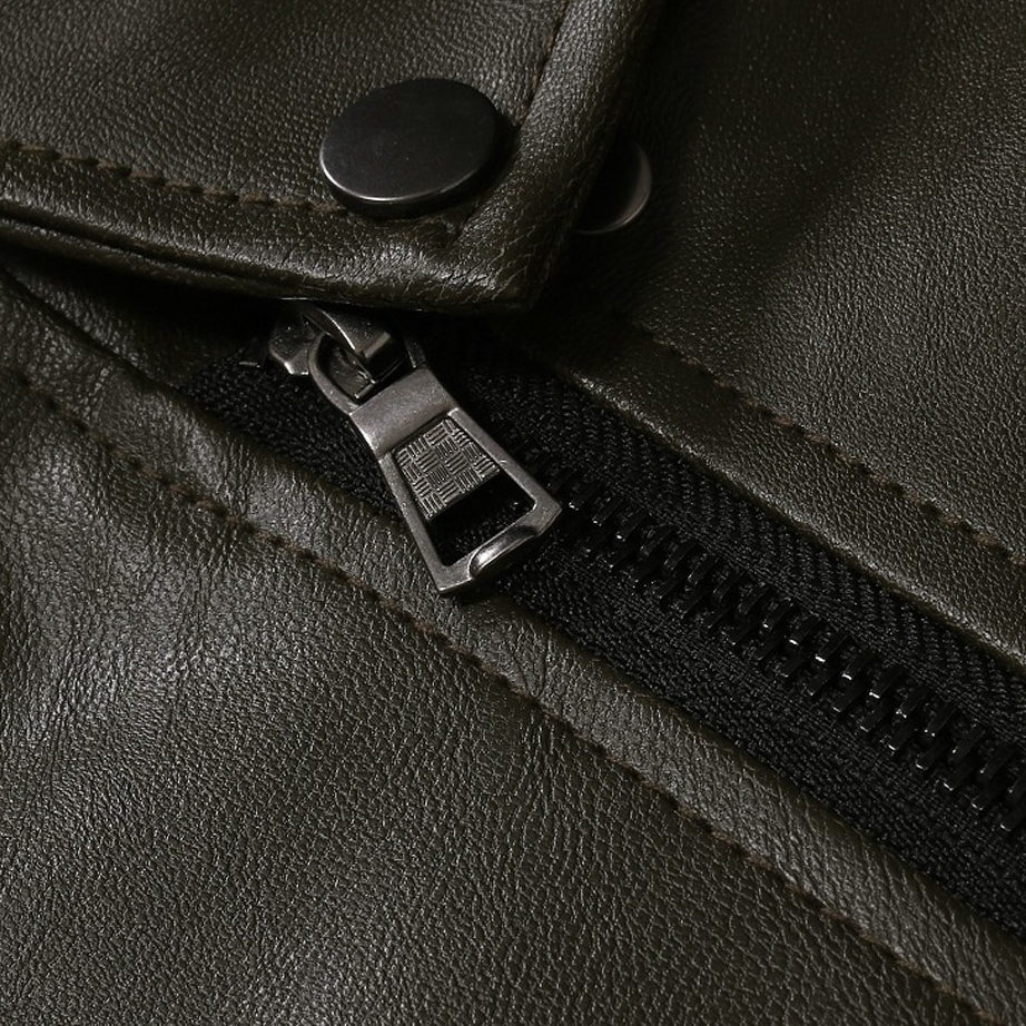 Close-up of a stylish oblique zipper on a men's PU leather biker jacket in dark green.