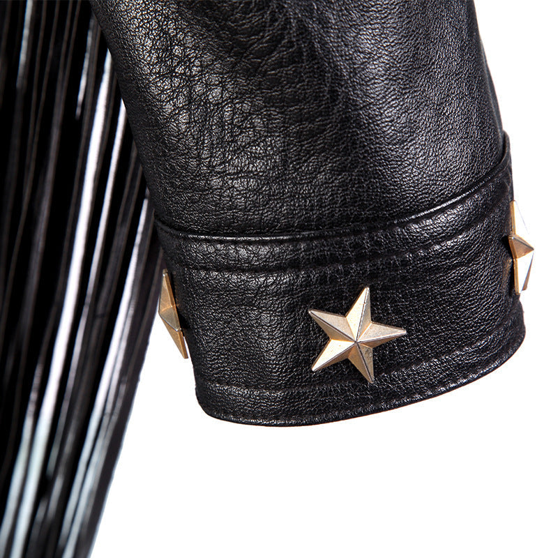Close-up of biker leather jacket sleeve with gold star studs and black tassels, showcasing unique texture and style.