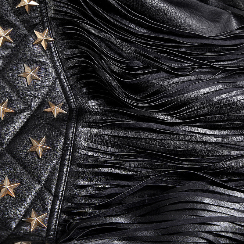 Close-up of black leather jacket with tassels and star embellishments, showcasing rich textures and edgy design.