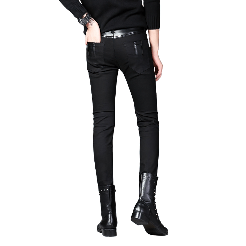 Back view of trendy men's black patchwork skinny trousers styled with biker boots.