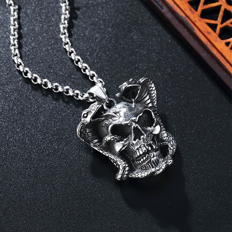 Biker pendant necklace featuring a detailed devil skull skeleton and snake design on a stainless steel chain.