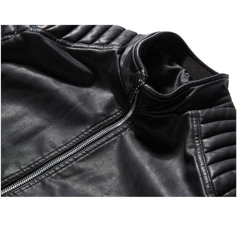 Close-up of a black biker PU leather jacket featuring a sturdy zip and quilted shoulder details.