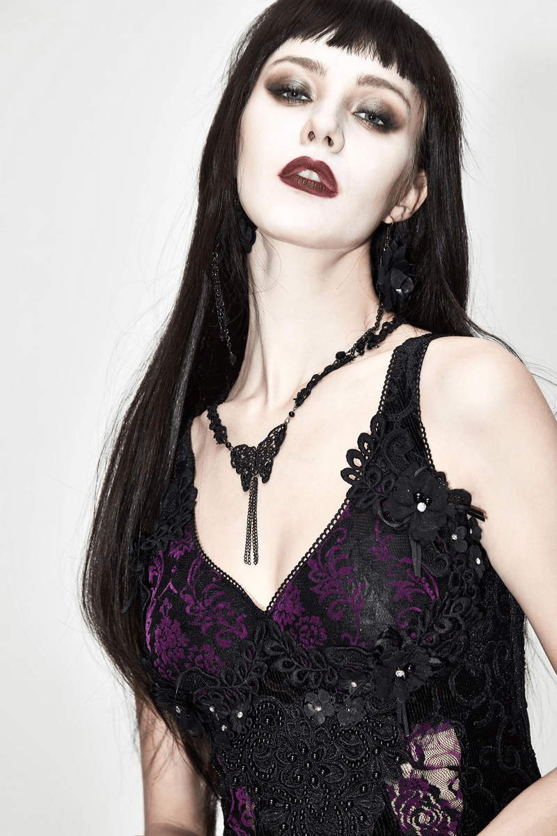 Gothic sexy black and purple lace dress worn by a model with long dark hair and bold makeup.