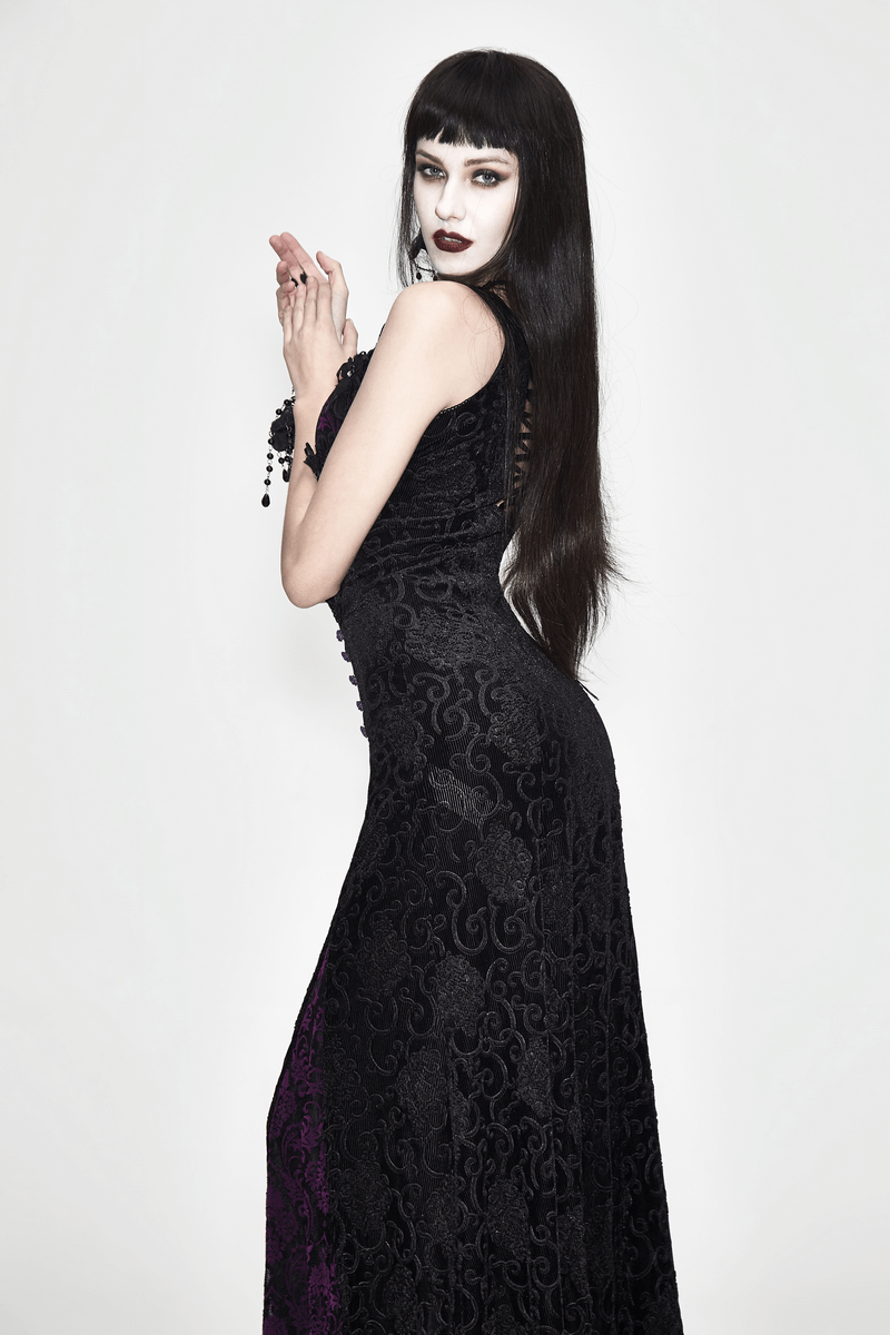 Woman in a black and purple gothic lace dress showcasing elegant style and intricate lacing details.