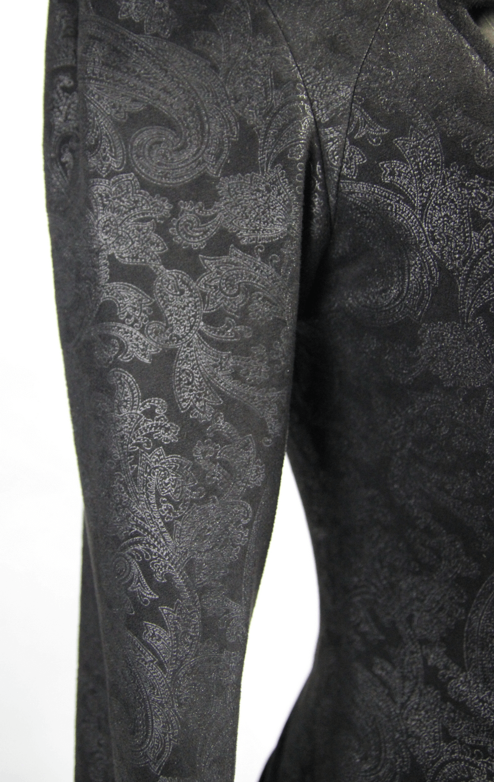 Close-up of the black embossed fabric detail showcasing intricate patterns on a gothic long coat sleeve.