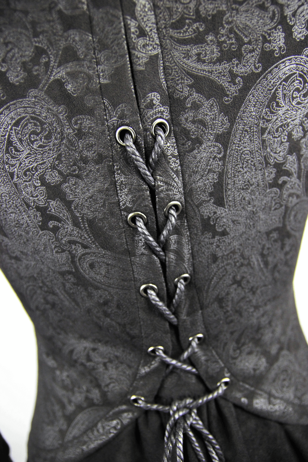 Close-up of black and red embossed coat featuring intricate lacing details for a Gothic style.