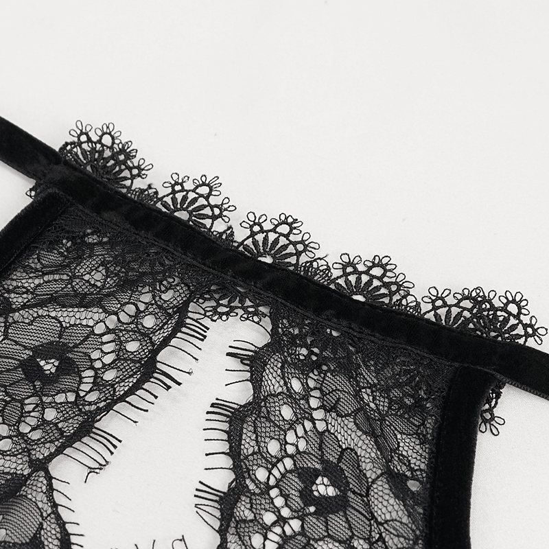 Close-up of black lace detailing on a gothic-style women’s bra, showcasing elegant floral patterns and texture.