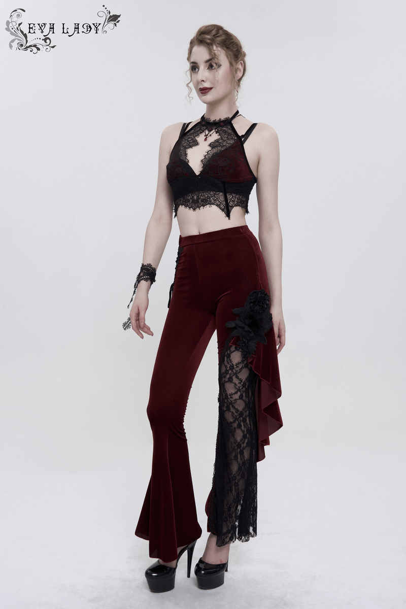 Woman in black and red gothic lace bra and stylish flare pants, showcasing elegant lingerie fashion.