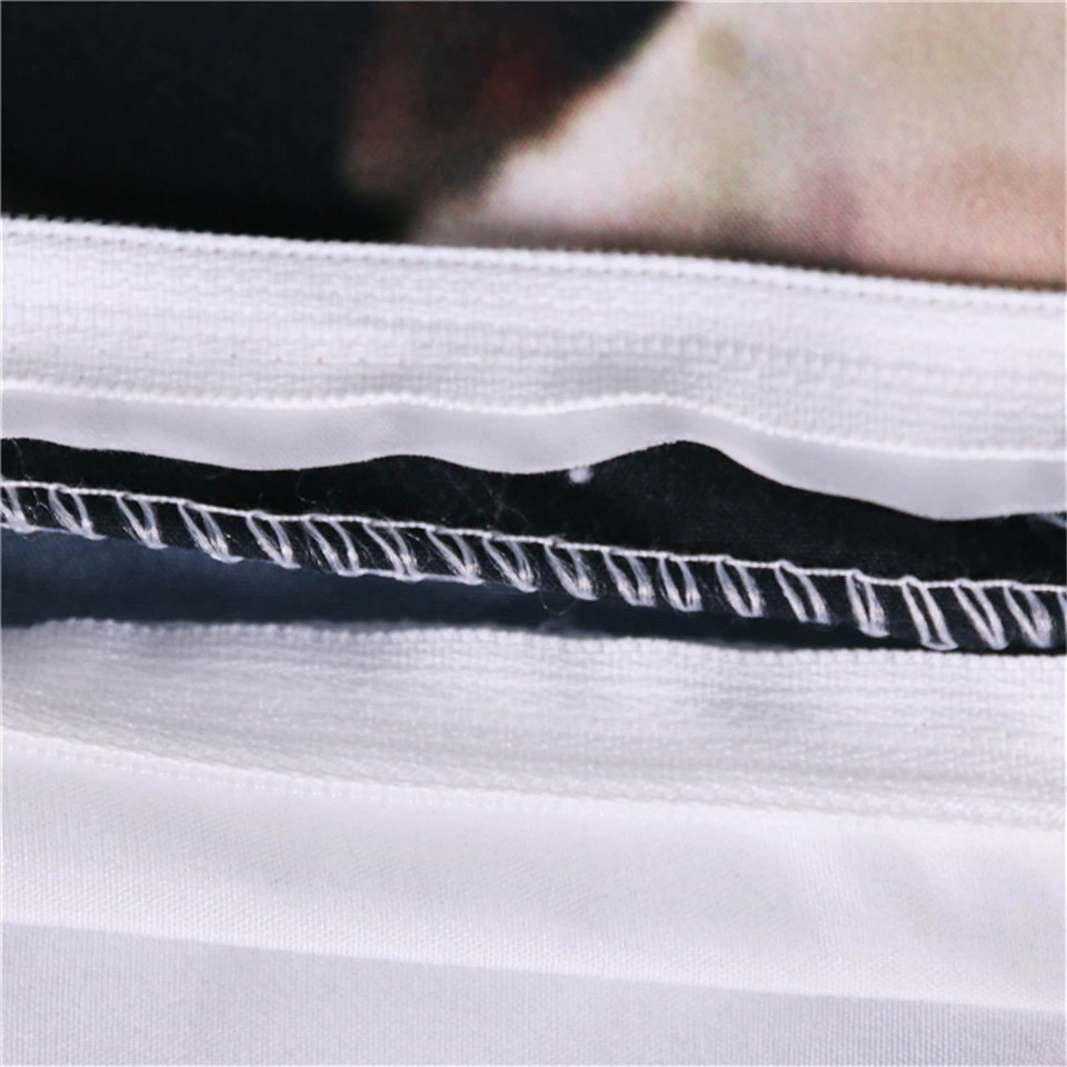 Close-up of the stitching detail on a gothic black and white bedding set with skeleton print.
