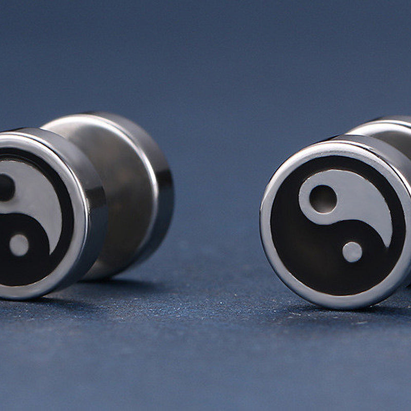 Black and white yin-yang stainless steel stud earrings, stylish unisex jewelry with polished finish.