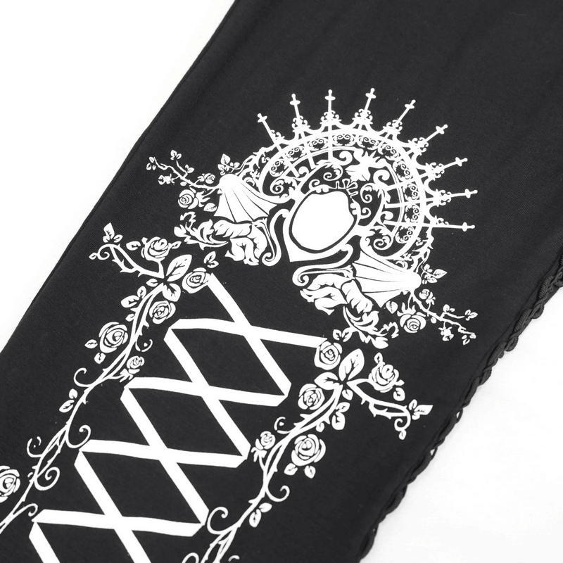 Close-up of black and white gothic patterned leggings featuring elegant floral design and stylish lacing details.