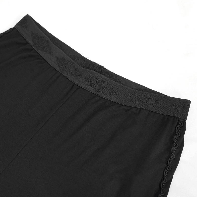Close-up of the waistband of black elastic gothic leggings with stylish lacing details, showcasing quality fabric and design.