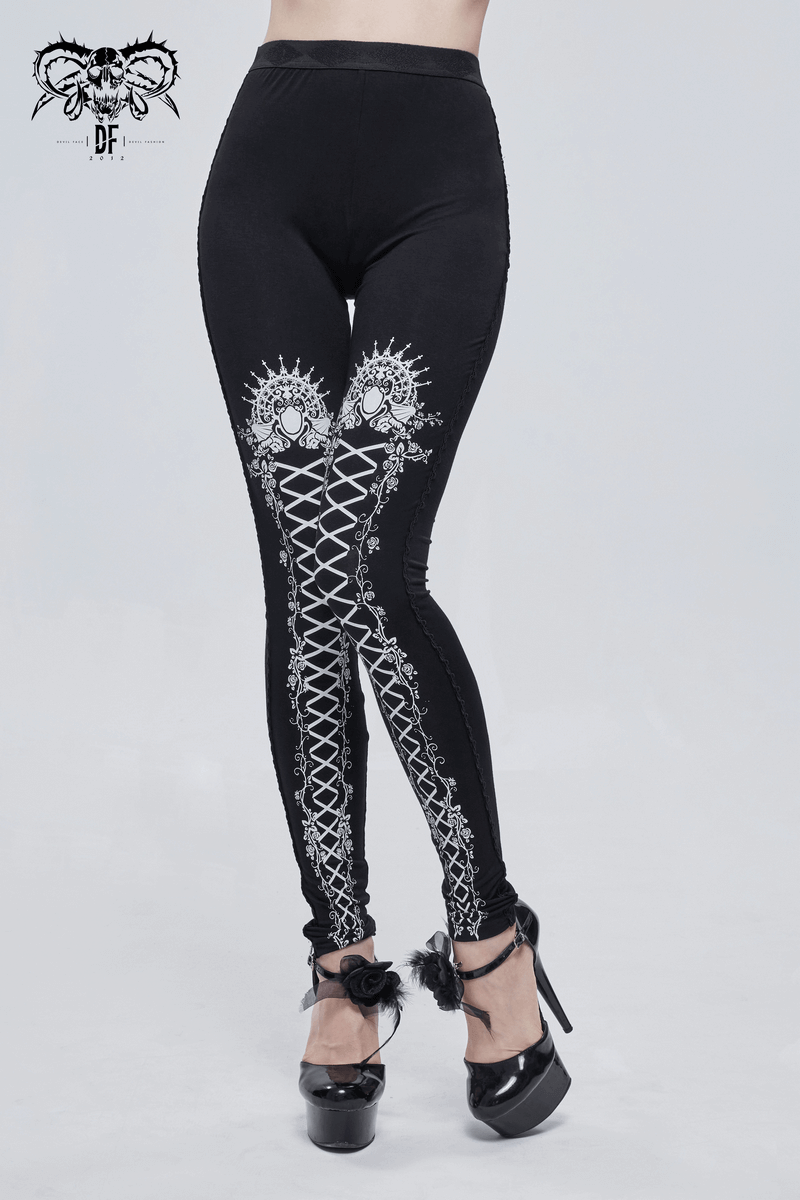 Stylish black elastic gothic leggings featuring unique lace-up and intricate white patterns for a trendy look.