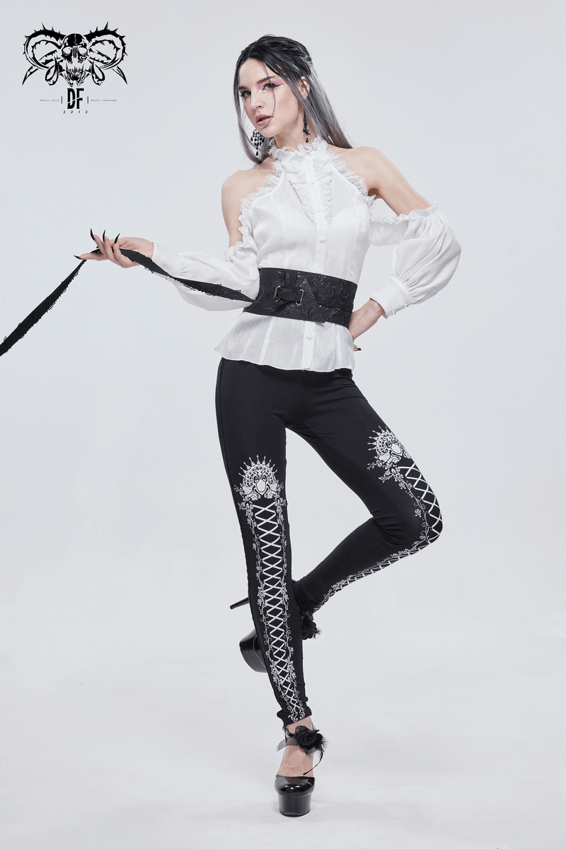 Model showcasing black and white gothic patterned leggings with stylish lacing, paired with a chic blouse.