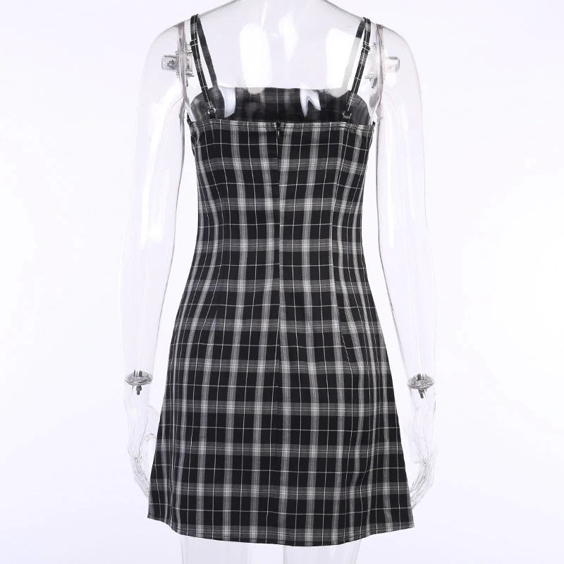 Back view of a black and white plaid women mini dress with sleeveless design and empire waistline.