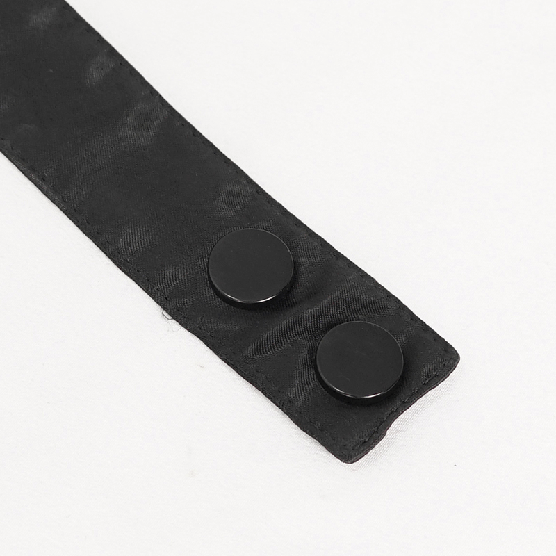 Close-up of black lace bowtie strap with two round black buttons, showcasing vintage gothic style.
