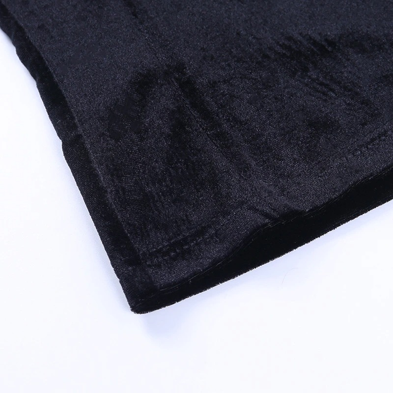 Close-up of the textured hem of a black gothic women's top, showcasing soft corduroy and mesh details for a chic look.