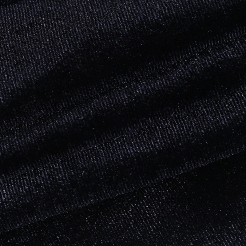 Close-up of black corduroy fabric showcasing a soft, luxurious texture for gothic women's fashion.