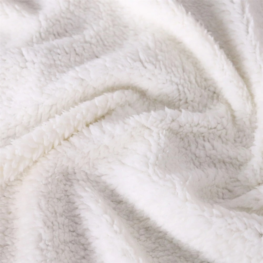 Cozy white sherpa fleece fabric, soft and plush for warm blankets and bedspreads.
