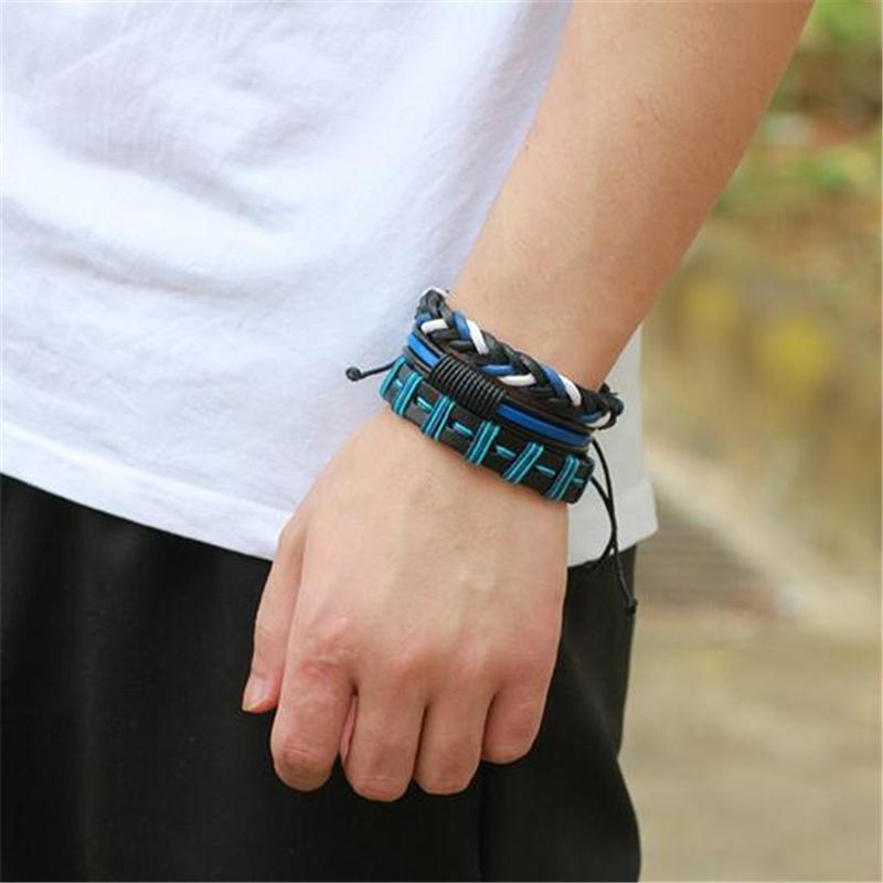 Stylish black and blue leather bracelet set worn on wrist, showcasing geometric design and braided style for men.