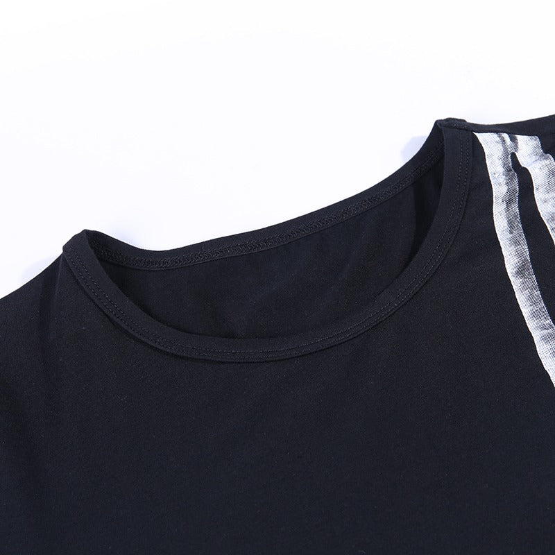 Close-up of the neckline of a black bodycon long sleeve dress with a stylish silver print accent.
